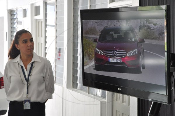 Jermaine Barnaby/Photographer
Jacqueline Sangster General manager Silver Star Motors showing a video of the cars at The New E-Class Sedan launched on Monday, September 9, 2013 Silver Star Motors Limited, South Camp Rd, Kingston.