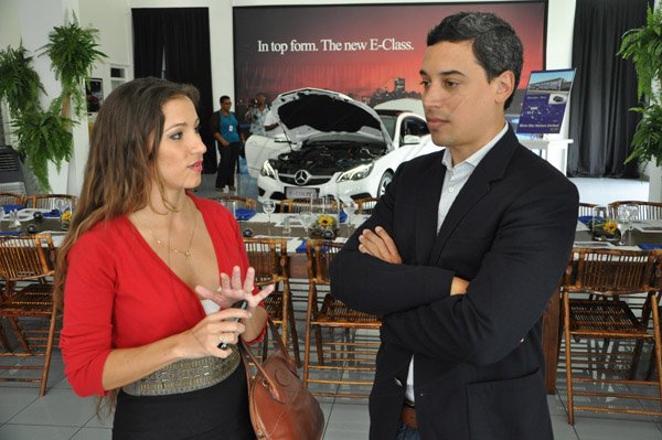 Jermaine Barnaby/Photographer
Christina Benjamin (left) Producer and Editor Wealth Magazine and Travis Mac Millan Managing Director MacMillan advertising chat during the showcasing of The New E-Class Sedan launched on Monday, September 9, 2013 Silver Star Motors Limited, South Camp Rd, Kingston.