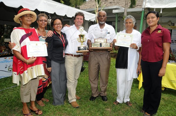 Gladstone Taylor/Photographer

Jason Henzell (centre) and Hursley Moxam (third right) of the Treasure Beach Community Development Association show off the trophies and certificates the community received after winning the National Best Community Competition 2011-2012. Joining the celebrations are community members Denise Wedderburn (left), Fern Falconer Luecke (second left), Kerry-Jo Lyn of the Digicel Foundation (third left), community member Jeanne Genus (second right), and Natalie Bradford-Remekie, Social Development Commission officer for Treasure Beach. The awards ceremony was held at the Stella Maris Pastoral Centre yesterday. August 23