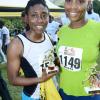 Rudolph Brown/Photographer
Kim-Marie Spence, (left) and Murlene Dudley pose with their trophy after the Best Dressed Chicken 5K Road Race Series 2013 at Hope Garden on Sunday, March 24, 2013.