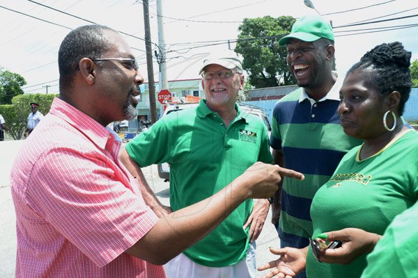 Ian Allen/Staff Photographer
The PNP's Luther Buchanan left, shares a joke with the JLP's Deborah "Sophia" Larmond right, Gregory Mair second left and Robert Miller during the Cassia Park Division Bi-Election at Calvary Gospel Assembly.