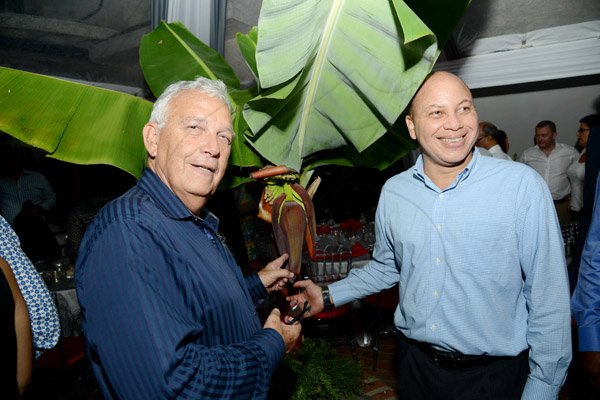 Rudolph Brown/Photographer
Business Desk
Charles Johnston, (left) Chairman of the Jamaica Producers Group and Group Managing Director Jeffrey Hall looks at a banana tree at a dinner hosted by the Chairwoman of the Bank's board, Mrs. Sylvia Chrominska and the Head of International Banking in Toronto at Tavistock Terrace in Jack's Hill on Wednesday, August 28, 2013