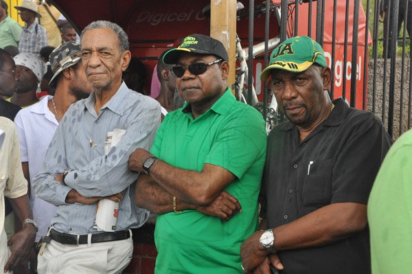 Jermaine Barnaby/Photographer
Anthony Johnson (left) among JLP stalwarts Edmund Bartlett (center) and Rudyard Spencer as they viewed the protest against bus fare increase in Half way Tree on Monday August 25, 2014.
