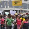 Jermaine Barnaby/Photographer
Scores of demonstrators converged on the National Works Agency corporate office as they carried out a protest against bus fare increase in Half way Tree on Monday August 25, 2014.