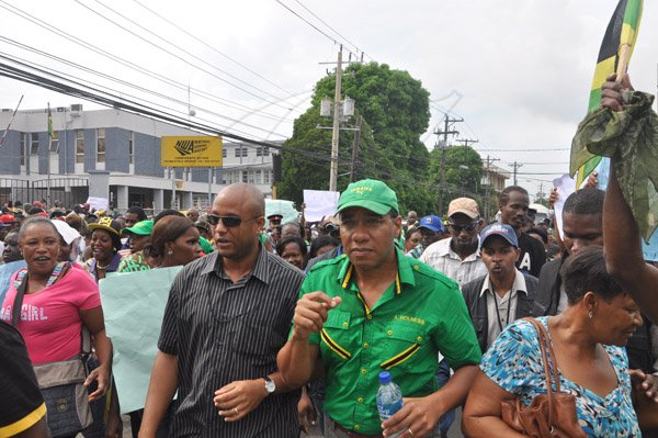 Jermaine Barnaby/Photographer
Opposition leader Andrew Holness lead a large group of prostestors protesting against bus fare increase in Half way Tree on Monday August 25, 2014.