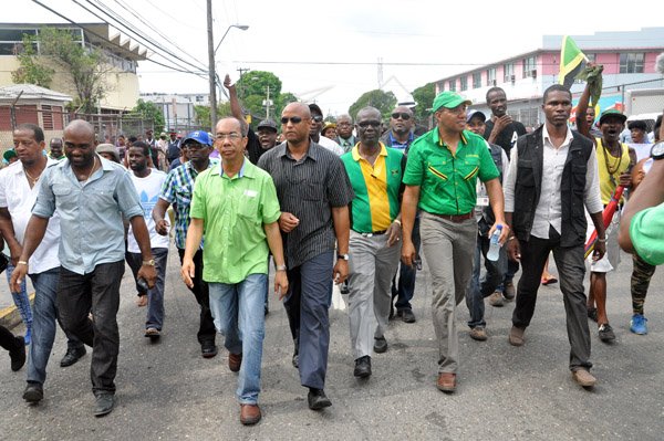 Jermaine Barnaby/Photographer
From left Andrew Wheatley, Horace Chang, Desmond McKenzie and Oppsition leader Andrew Holness lead a large contingent of demonstrators protesting against bus fare increase in Half way Tree on Monday August 25, 2014.
