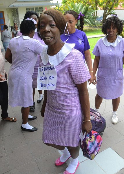 Rudolph Brown/Photographer
Sharon Smith, (left) dressed in children's uniform enter the St Peter and Paul church for the school devotion along with other teachers on Teachers' Day at St Peter and Paul Prep School, 120 Old Hope Road on Wednesday, May 8-2012