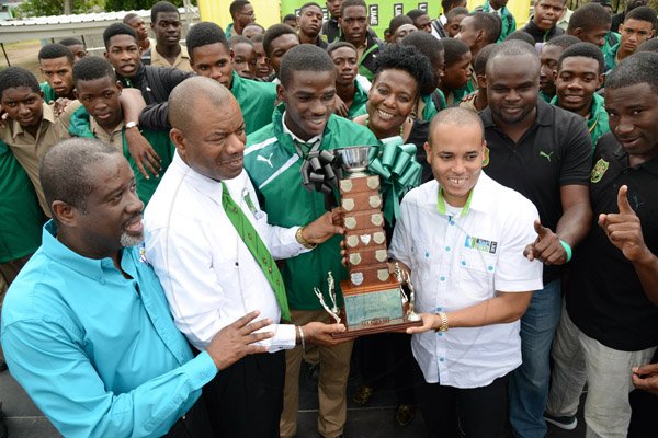 Rudolph Brown/Photographer
From left are Rev Carl Johnson Chairman of Calabar,  Principal of Calabar High, Albert Corcho, Calabar High School captain and star performer, Michael O’Hara and Carlo Redwood, Vice President of Marketing at LIME at the Calabar high school celebration at the school after their victory on Saturday at champs, March 28, 2015.