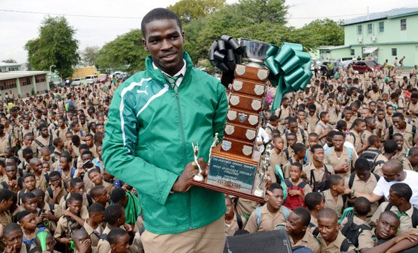 Rudolph Brown/Photographer
Calabar High School captain and star performer, Michael O’Hara holding trophy at the Calabar high school celebration at the school after their victory on Saturday at champs, March 28, 2015.