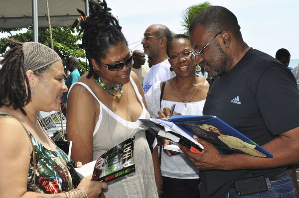Janet Silvera Photo
 
Kwame Dawes (right) autographing books at Calabash