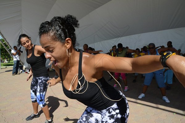 Rudolph Brown/Photographer
Francisca Griffiths, (left) and Shani McGraham- Shirley of Chai Studios conducts the class at the RBC Royal Bank Caribbean Children's Cancer Fund, " A Mile for a Child" join with family and friends participate in a charity walk and a fun class of Zumba and aerobics session at the Emancipation Park in New Kingston on Saturday, September 8-2012