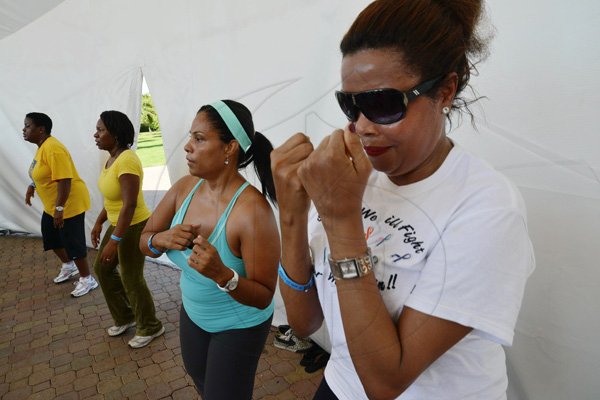 Rudolph Brown/Photographer
Yulit Gordon, (right) Executive Director of Jamaica Cancer Society at the RBC Royal Bank Caribbean Children's Cancer Fund, " A Mile for a Child" join with family and friends participate in a charity walk and a fun class of Zumba and aerobics session at the Emancipation Park in New Kingston on Saturday, September 8-2012