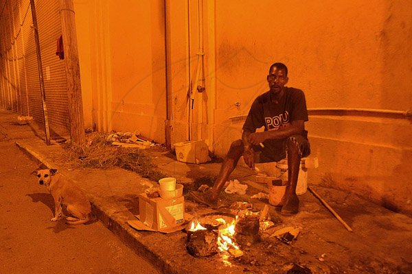 Ian Allen/Photographer
A homeless man cooking Downtown.