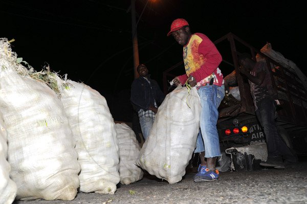 Norman Grindley/Chief Photographer
(Capturing Kingston) Unloading market truck by the Coronation market in downtown Kingston at two am Saturday Morning