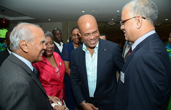 Rudolph Brown/Photographer
Business Desk
Haitian President H.E. Michel Martelly, (second right) greets Dennis Lolar,(left) Board Director, Carol Guntley, director general in the Ministry of Tourism and Jagmohan Singh, (right) Acting CEO of Caribbean Airline at the Caribbean Airlines awards and Corporate Event at the Jamaica Pegasus Hotel on Friday, November 15, 2013