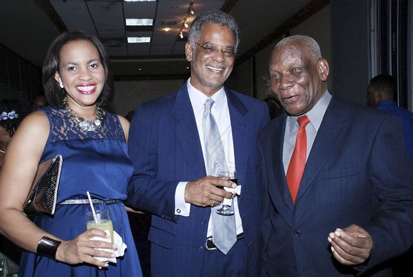 Colin Hamilton /Freelance Photographer

Taking some time away from their conversation Claudine Heaven, and husband Trevor Heaven pose for a photo op with  Rev. Dr. Webster Edwards at  the Carreras  50th Anniversary Gala & Awards Banquet at the Pegasus on September 5, 2012.
