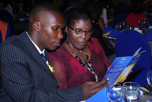 Colin Hamilton /Freelance Photographer
Awardee Peton Muschette (UWI Mona) looks over the Programme with his mother Josette Muschette.at the Carreras  50th Anniversary Gala & Awards Banquet at the Pegasus on September 5, 2012.