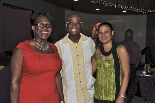 Janet Silvera Photo
 
Rodwell Williams (centre) is all smiles with friend Paula Llewellyn (left) and wife Felice.




 at a cocktail reception at the Iberostar Suites in Montego Bay last Saturday night.