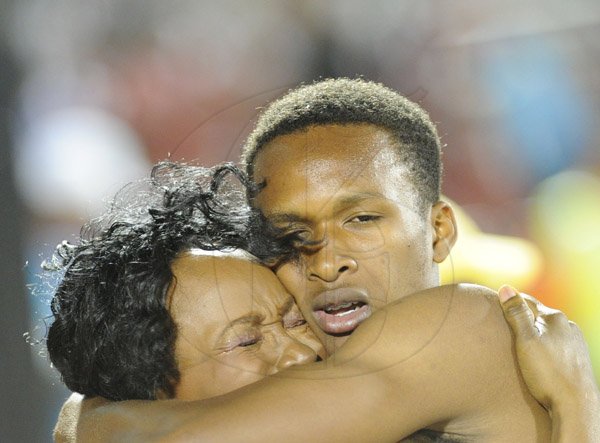 Ricardo Makyn/Staff Photographer 
Jaheel Hyde hugs His Mother Angela Hussett after shattering the Boys open Record for the 400 Meter Hurdles on Day 4 of Champs 2014