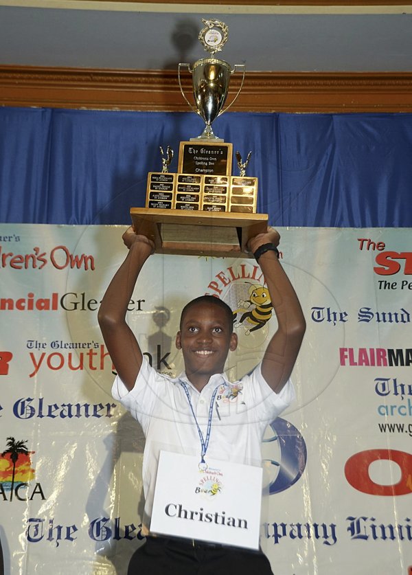 Ian Allen/Photographer
Christian Allen of Ardenne High School and Spelling Bee Champion for 2013, hold the trophy shortly after he won the championship at the Jamaica Pegasus Hotel in Kingston on Wednesday.