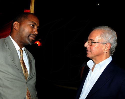 Winston Sill / Freelance Photographer
The Chairman of Jamaica Public Service Company (JPS)  Hisatsugu Hirai host Chinese New Year's Reception, held at Plymouth Close, St. Andrew on Tuesday night January 24, 2012. Here are Julian Robinson (left); and Paul Issa (right).