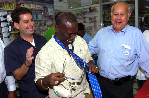 Norman Grindley/Chief Photographer
Oliver Clark, (right) Chairman and Managing director of the Gleaner Co. seems to be in a jovial mood after he present Mayor of Kingston Desmond McKenzie a Gleaner tie during their Christmas in the city shopping tour December 15, 2010 downtown Kingston. Looking on is Jimmy Joseph.