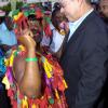 Norman Grindley/Chief Photographer
A jonkanoo performer grabs Prime Minister Bruce Golding for a dance during Christmas in the City activities on Sutton Street, downtown Kingston yesterday.