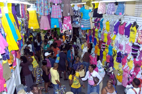 Norman Grindley/Chief Photographer
Shoppers search through clothing in a shop, downtown, Kingston, yesterday during the 'Christmas in the City, Downtown comes Alive' event. A large crowd turned out for the event which went on until late last night.