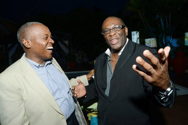 Rudolph Brown/Photographer
Heston Hutton,(left) managing director of CSS, a subsidiary of JCCUL chat with Dwight Moore Chairman and CEO Kia Motors at the JCCUL cocktail reception in honour of the existing stakeholders in the Jamaica Credit Union E-Payment Services (JCUES) its new mobile payment system at 9 Rosemarie Drive in St. Andrew on Friday, August 16, 2013