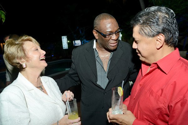 Rudolph Brown/Photographer
Becky Stockhausen (left) Executive Director of the American Chamber of Commerce laughs heartily as she chats with Dwight Moore, (centre) Chairman and CEO Kia Motors and David Wan 

JCCUL cocktail reception in honour of the existing stakeholders in the Jamaica Credit Union E-Payment Services (JCUES) its new mobile payment system at 9 Rosemarie Drive in St. Andrew on Friday, August 16, 2013