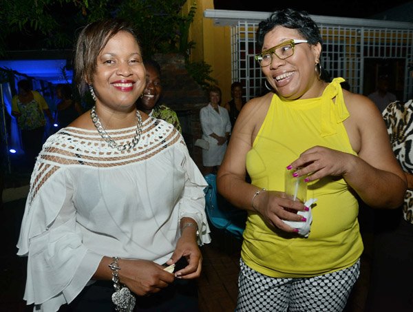 Rudolph Brown/Photographer
Dianna Blake-Bennet, (right) chat with Tashia Hutton at the JCCUL cocktail reception in honour of the existing stakeholders in the Jamaica Credit Union E-Payment Services (JCUES) its new mobile payment system at 9 Rosemarie Drive in St. Andrew on Friday, August 16, 2013