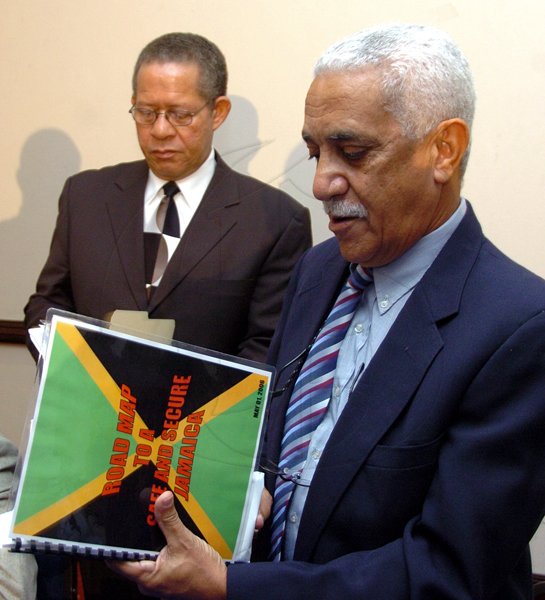 Rudolph Brown/Chief Photographer
Bruce Golding (left), Leader of the Opposition, and Colonel Trevor MacMillan, former commissioner of police, examine the report put together by the Special Task Force on Crime (STFC), at a press conference held in April at the Jamaica Pegasus, New Kingston. The STFC, headed by Col. MacMillan, was convened by Mr. Golding last December.