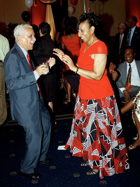 Winston Sill / Freelance Photographer
Col. Trevor MacMillan shakes a leg with Trinidad & Tobago's Ambassador Yvonne Gittens-Joseph. at the 47th Independence Day reception, held at the Jamaica Pegasus hotel, New Kingston on Monday night.

 August 31, 2009.