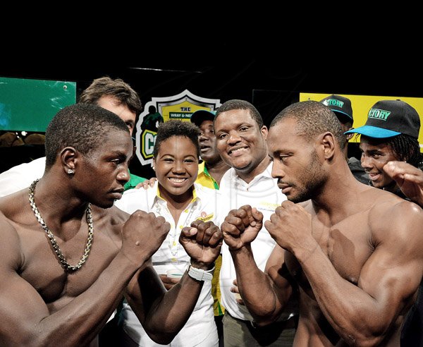 Winston Sill/Freelance Photographer
Guyana's Derick 'Dangerous' Richmond (left) of the Yellow Team squares off with Jamiaca's Sakima Mullings (Green Team at the launch of this year's J Wray and Nephew White Overproof Rum Contender Series at TVJ Studios, Lyndhurst Road, St Andrew on Thursday night. Also in photograph are Chloe DaCosta (second left), brand manager, Schweppes and Cecil Smith (second right), group brand manager- rum, J Wray and Nephew.