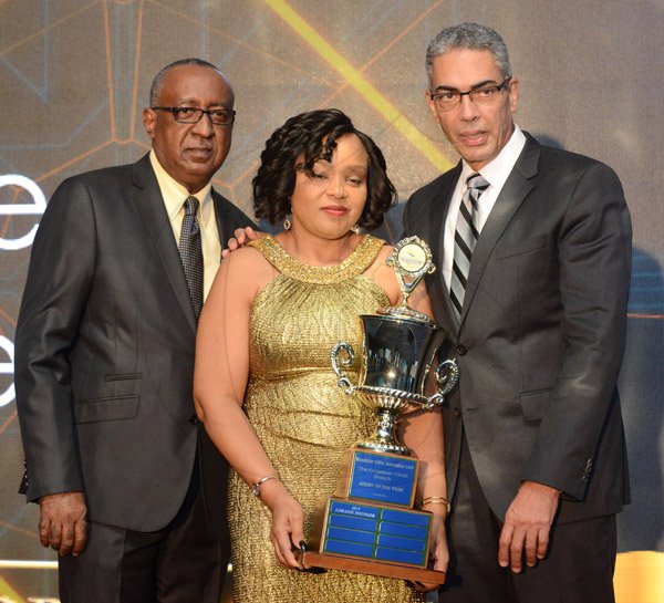 Rudolph Brown/Photographer
Richard Byles, (right) President and CEO of Sagicor and Pete Forrest, Senior Branch Manager of Sagicor Corporate Circle Branch presents the Agent of the Year Trophy to Lorraine Younger at the Sagicor Corporate CircleBranch awards at the Jamaica Pegasus Hotel in New Kingston on Friday, March 4, 2016
