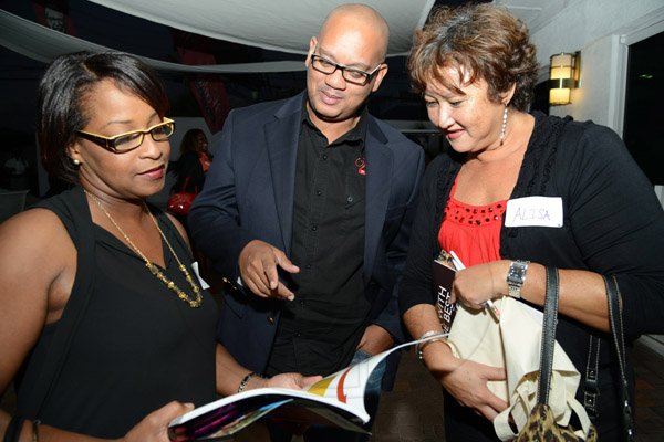 Rudolph Brown/Photographer
Leighton Davis, (centre) chairman of Creative Media and Events and organiser of Corporate Mingle chat with Alisa Lee, (right) Realtor of Millennium Properties Sales and Services and Sheryl Jenkins, Sales Associate at the Wealth Magazine corporate mingle at the Spanish Court Hotel in New Kingston on Friday, January 31, 2014