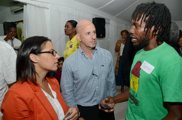 Rudolph Brown/Photographer
Tina Matalon director of marketing, Restaurants of Jamaica and her husband Gary Matalon chat with Courtney Waugh of Authentic Jamaican Clothing Line at the Wealth Magazine corporate mingle at the Spanish Court Hotel in New Kingston on Friday,January 31, 2014