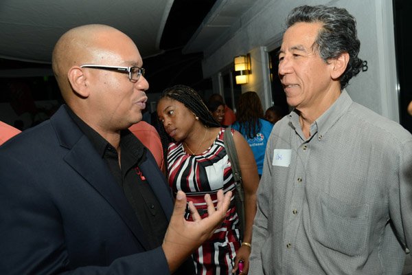 Rudolph Brown/Photographer
Business Desk
Leighton Davis, (left) chairman of Creative Media and Events and organiser of Corporate Mingle chat with Puma Jamaica's Carl Chang at the Wealth Magazine corporate mingle at the Spanish Court Hotel in New Kingston on Friday,January 31, 2014