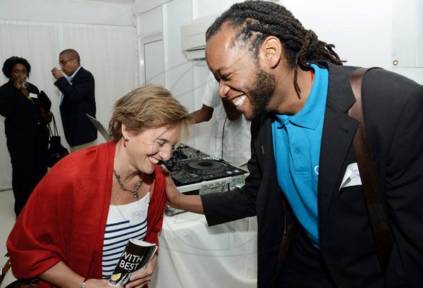 Rudolph Brown/Photographer
Marie Legault, (right)  Counsellor and Head of Cooperation - CIDA, Canadian High Commission share a joke with Tarik Perkins, Country Representative, Cuso International at the Wealth Magazine corporate mingle at the Spanish Court Hotel in New Kingston on Friday,January 31, 2014