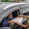 Jermaine Barnaby/Photographer
This motorist seems pleased to be purchasing a copy of the Gleaner newspaper from Shante Gapour (right)  at Manor Park  during The Gleaner's corporate street sale day on Monday September 8, 2014.