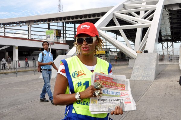 Jermaine Barnaby/Photographer
2009 Digicel Rising Stars winner, Shuga at the Transport center in Half Way Tree selling copies of the Gleaner during The Gleaner's corporate street sale day on Monday September 8, 2014.