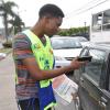 Jermaine Barnaby/Photographer
Digicel 2010 Rising Star winner Dalton Harris (left) tries to pursuade a motorist to buy a copy of The Gleaner newspaper during the company's corporate street sale day along Trafalgar road on Monday September 8, 2014.