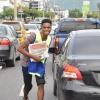 Jermaine Barnaby/Photographer
Digicel 2010 Rising Star winner Dalton Harris moves in traffic in a bid to sell copies of  The Gleaner newspaper during the company's corporate street sale day on Monday September 8, 2014.