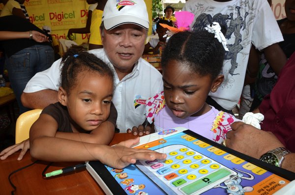 Rudolph Brown/Photographer
Butch Hendrickson, managing director of National Bakery looking at the children play at the Family Fun Day at the Do Good Jamaica, Kingston Book Festival at Emancipation Park on Saturday March 17-2012