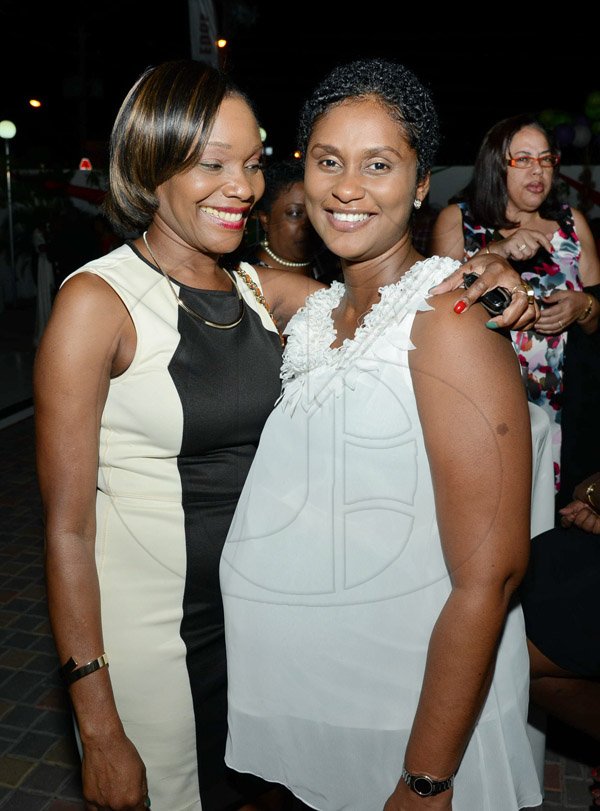 Rudolph Brown/Photographer
Audrey Tulloch, (right) chat with Patricia Fagan, (left) First Global Bank Branch Managerat the Credit Union Fund management Company Christmas party at the Spanish Court Hotel in New Kingston on Friday, December 13, 2013
