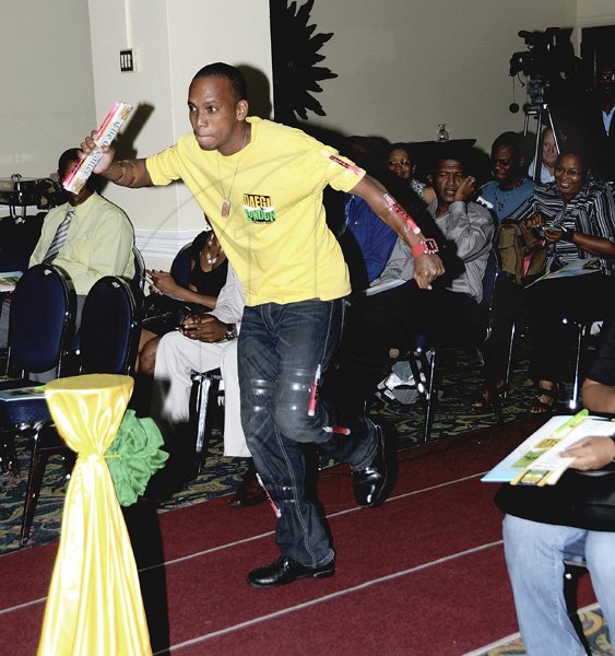 Winston Sill/Freelance Photographer
Gleaner employee Gavin Green participates in a symbolic relay to signal the start of the newspaper's Daegu to London Olympic coverage during yesterday's launch at The Knutsford Court Hotel in St Andrew.
