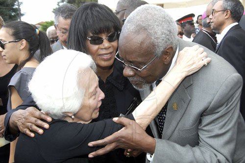 Ian Allen/Photographer
Maria Coore left, wife of the late David Coore is comforted by  former Prime Minister of Jamaica P.J.Patterson right and Opposition Leader Portia Simpson-Miller shortly after the funeral service at the Holy Trinity Cathedral on Saturday.