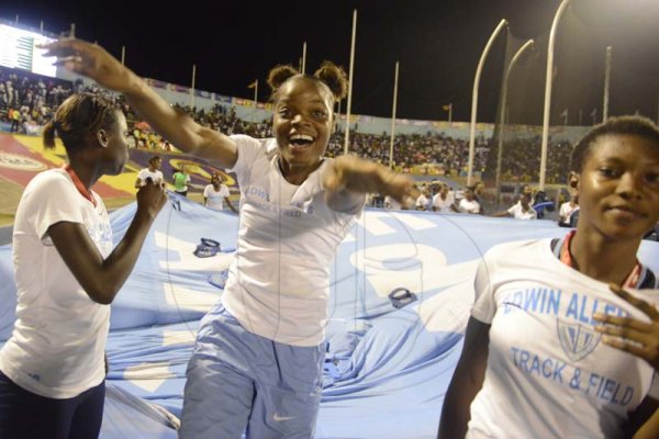 Shorn Hector/Photographer  Edwin Allen atheletes parade their flag after winning their sixth Champs title on day five of the ISSA/GraceKennedy Boys and Girls’ Athletics Championships held at the The National Stadium in Kingston on Saturday March 30, 2019