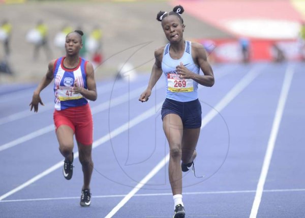 Shorn Hector/Photographer Fredricka McKenzie (right) of Edwin Allen wins heat four of the girls class one 100 meter dash onday three of the ISSA/GraceKennedy Boys and Girls’ Athletics Championships held at the The National Stadium in Kingston on Thursday March 28, 2019