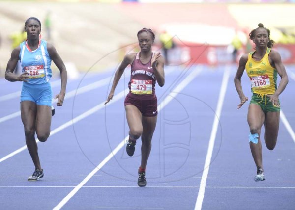 Shorn Hector/Photographer Kishawna Wallace of Holmwood Technical (center) wins heat five of the girls class one 100 meter dash onday three of the ISSA/GraceKennedy Boys and Girls’ Athletics Championships held at the The National Stadium in Kingston on Thursday March 28, 2019